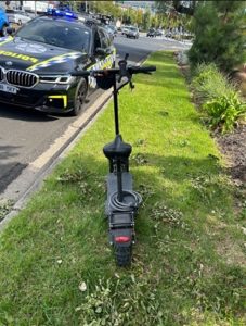 ‘Speeding and wrong side of road’: e-scooter rider charged after nearly hitting police car